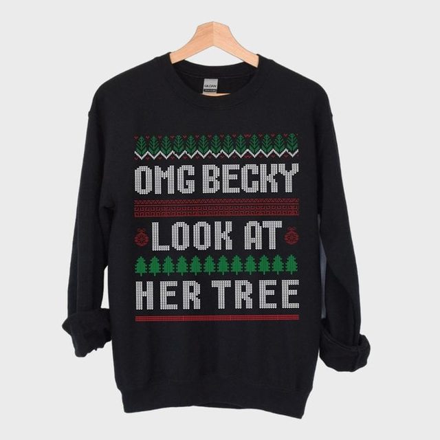 Sweatshirt hangs on a wooden hanger, displaying the phrase 