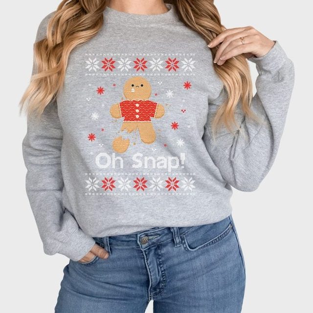 Sweatshirt displays a broken gingerbread man with 