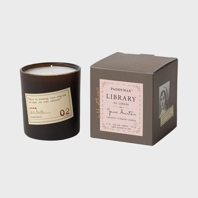 Candle sits beside matching box; labeled 