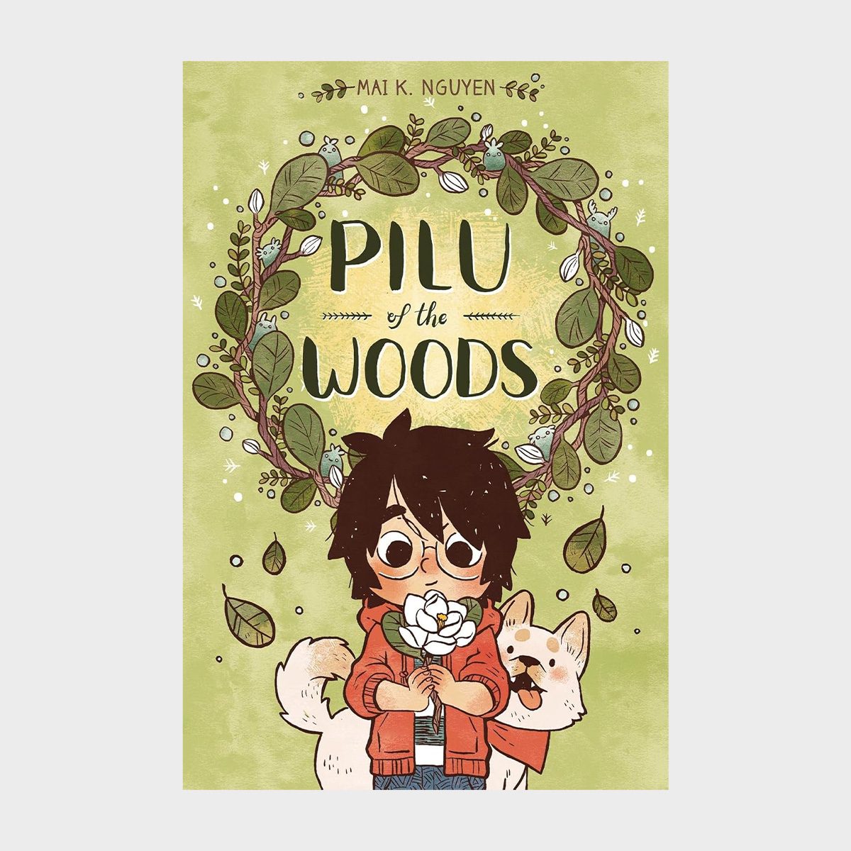 A young character holds a flower, accompanied by a cheerful dog, surrounded by leafy branches. Text reads: "Pilu of the Woods" by Mai K. Nguyen.