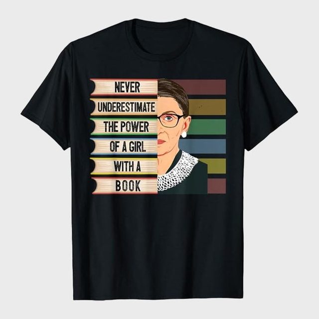 T-shirt features a stack of books beside a woman's portrait, with text: 