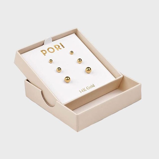 Gold stud earrings, arranged on a white card labeled 