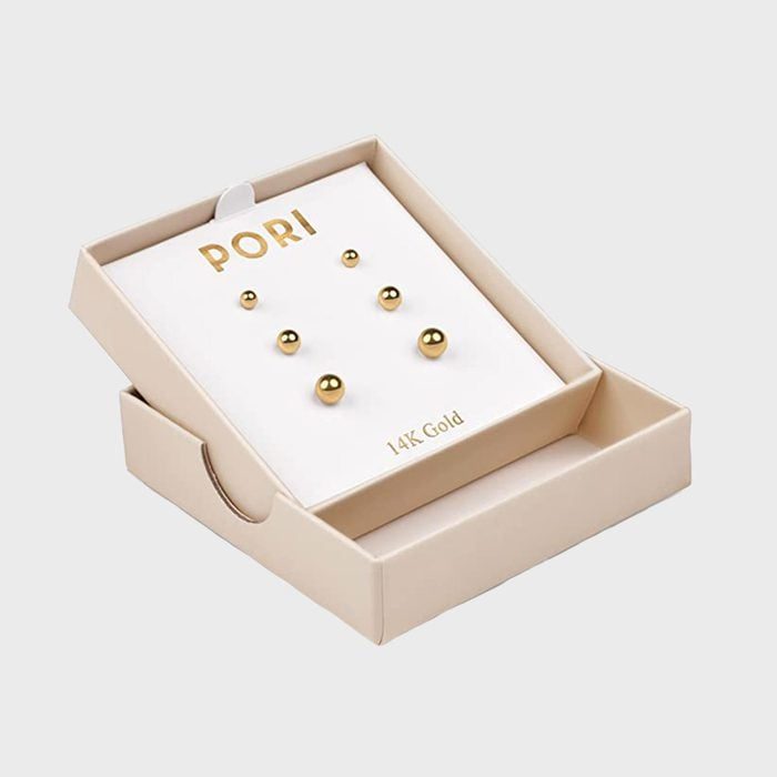 Gold stud earrings, arranged on a white card labeled 