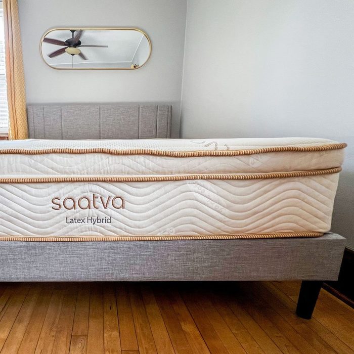 Mattress rests on a gray bed frame; features the text 