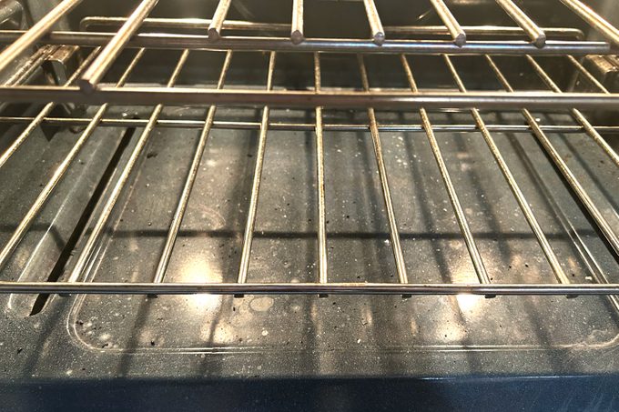 A close-up view of an oven interior showcasing a metal rack positioned inside, highlighting its design and functionality