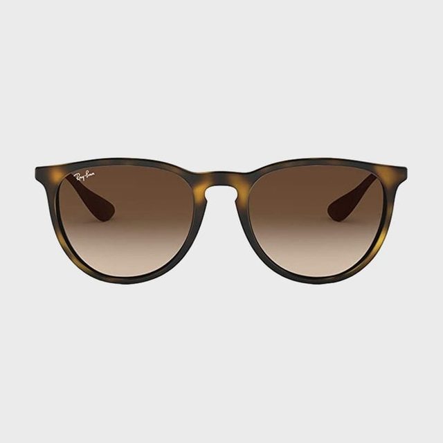 Sunglasses with brown gradient lenses are displayed against a white background. 