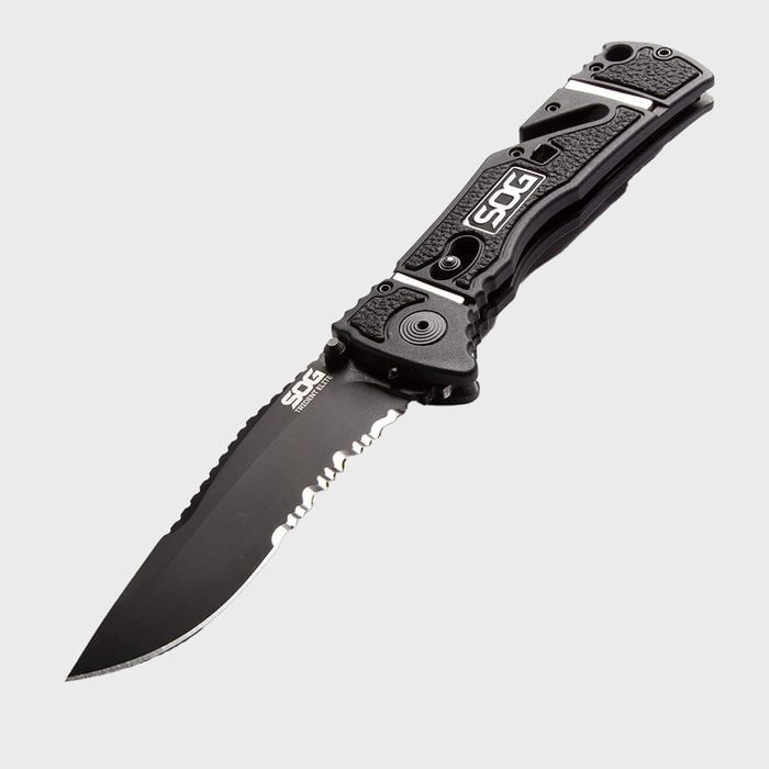 Knife lies open, displaying a serrated blade, on a plain background. Text on blade and handle reads 