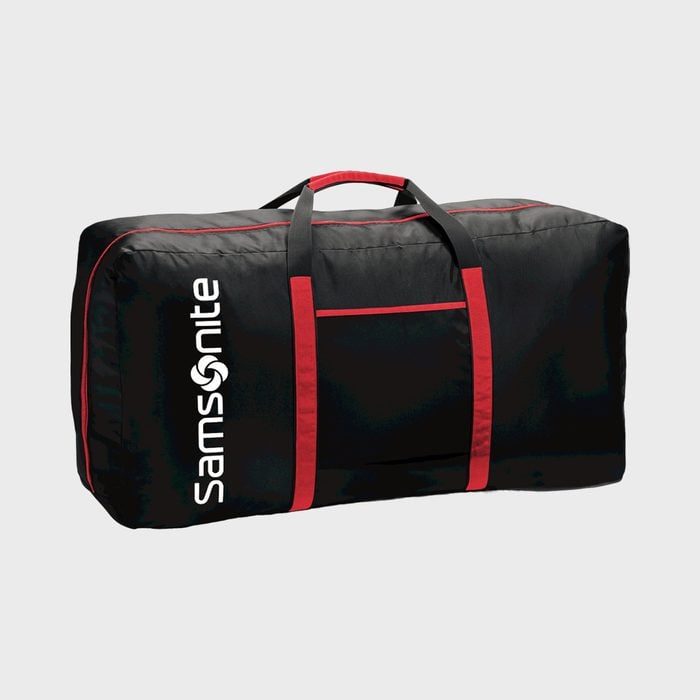 A black duffel bag with red accents sits upright; 