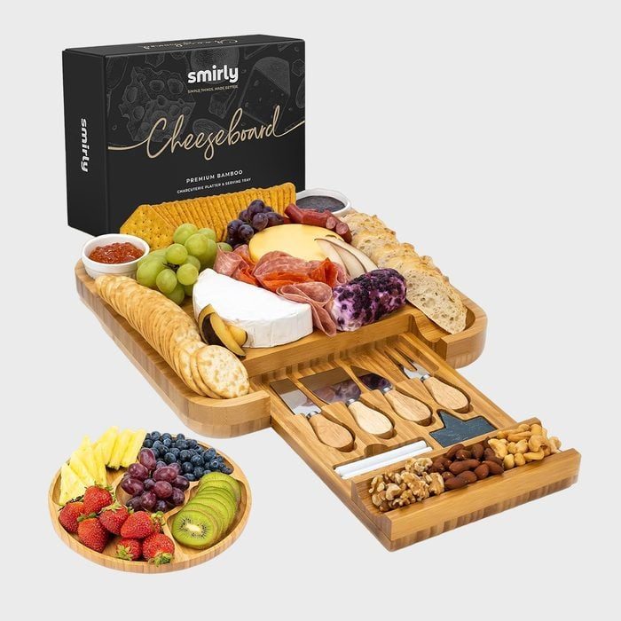 Cheeseboard displaying assorted cheeses, crackers, meats, and fruits; cutlery drawer extends outward. Black box labeled 