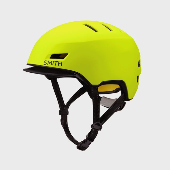 A bright yellow helmet rests with black straps, labeled 