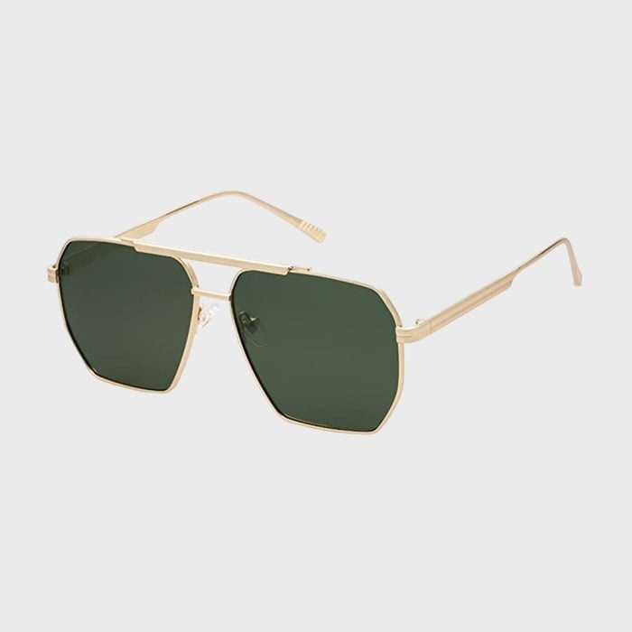 Sunglasses feature gold metal frames with dark green lenses, resting on a plain white background.