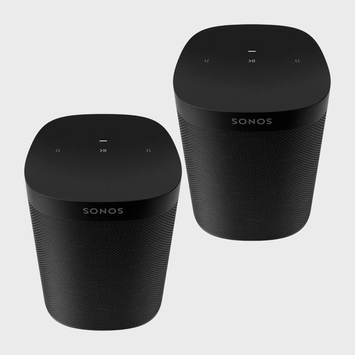 Two black Sonos speakers sit side by side on a light background, displaying tactile controls on top.