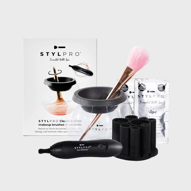Makeup brush cleaning kit includes electric spinner, brush holder, cleaning bowl, and sachets. Box and packaging feature product instructions and branding logos.