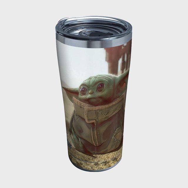 A tumbler features a small green character in a brown coat, standing outdoors with a blurred background behind.