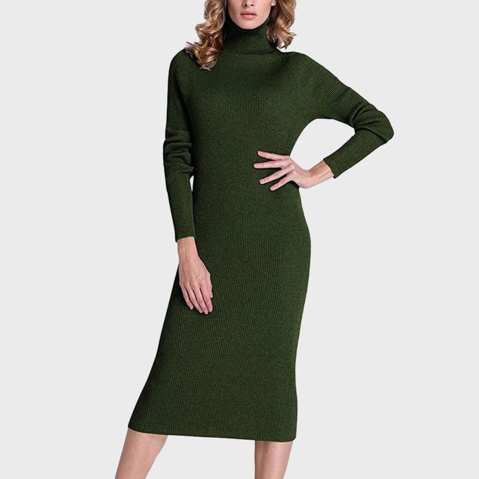 A green sweater dress, with long sleeves and turtleneck, is worn by a person posing in a neutral setting.