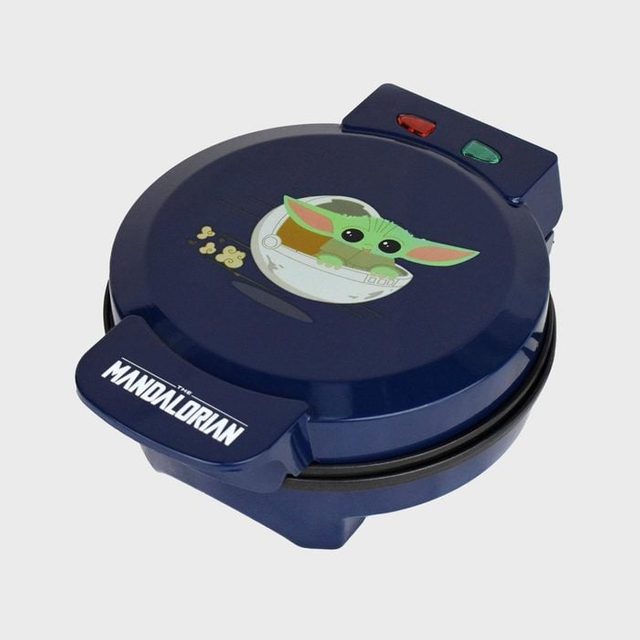 Waffle maker shows cartoon alien in a cradle, featuring 