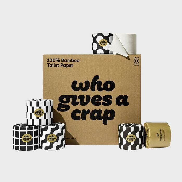 Cardboard box displays toilet paper rolls; some have bold patterns. Text reads, 