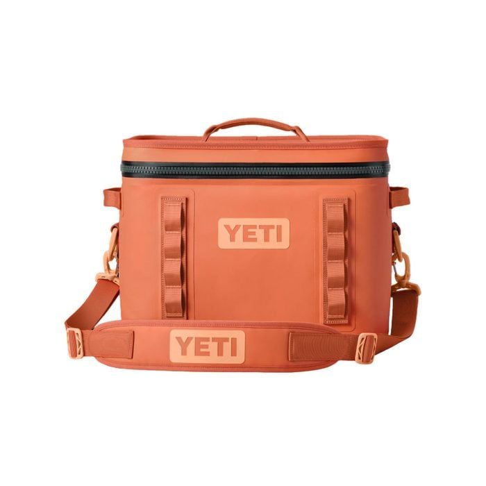 Orange cooler bag with carrying strap, labeled 