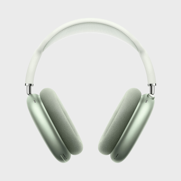 Headphones are resting; metallic green ear cups with a white headband on a plain gray background.