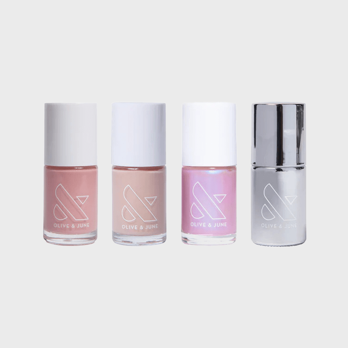 Four nail polish bottles stand side by side, showing pastel pink, nude, shimmery pink, and silver colors; labeled 