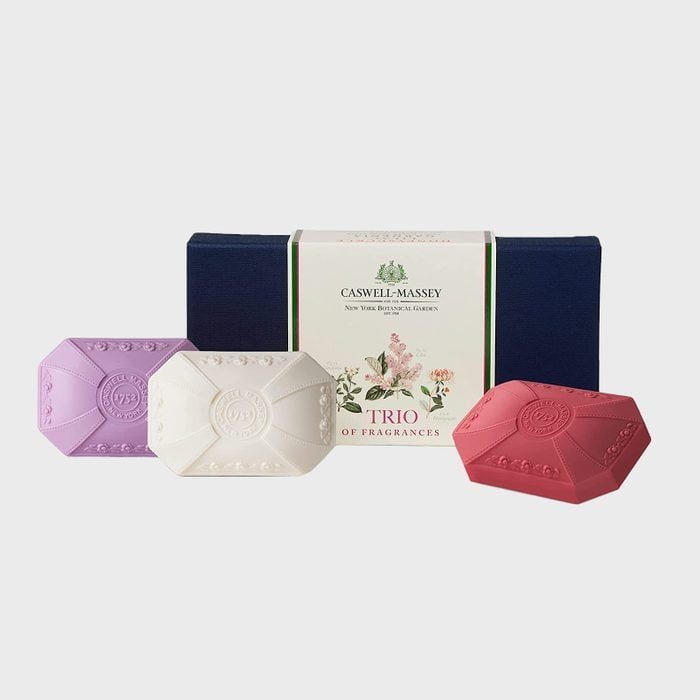 Three decorative soaps are arranged in front of a box labeled 