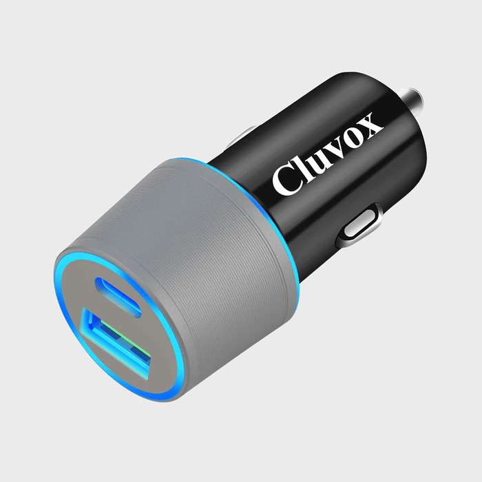 Car charger with USB ports, glowing blue, in a studio setting. The text 