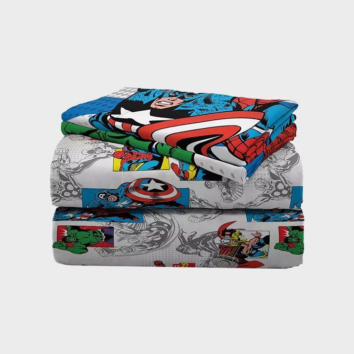 Stacked bedding features colorful superhero comic characters, including figures and logos, folded neatly against a plain background.