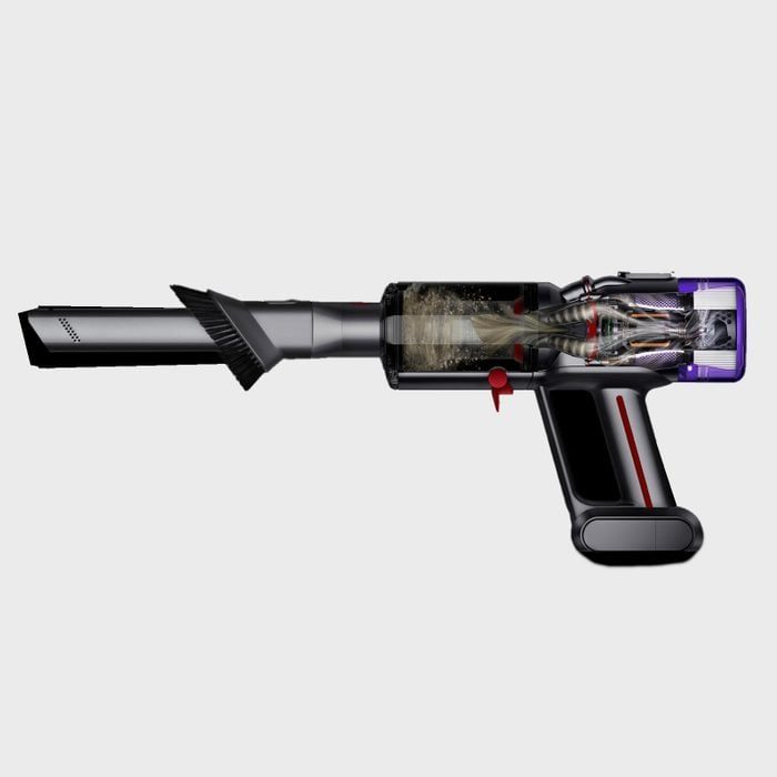 Cutaway diagram showing a handheld vacuum in action, dust swirling inside a transparent chamber. Device appears in a plain, light gray background.