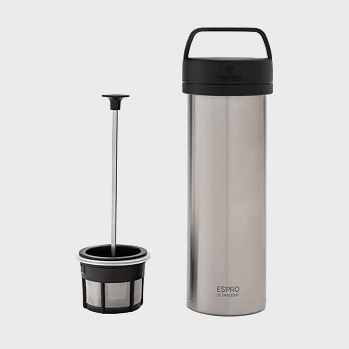 Stainless steel travel coffee press stands upright; filter basket beside it; minimalistic design on a gray background. Text reads 