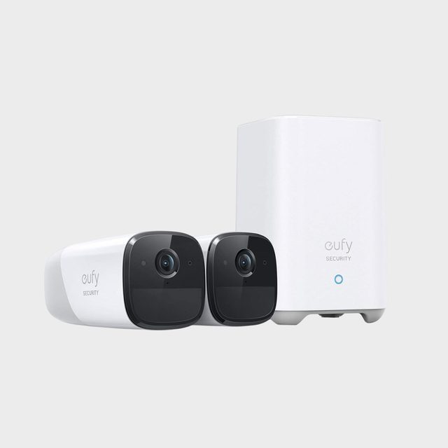 Two Eufy security cameras positioned beside a white base station, against a plain background.