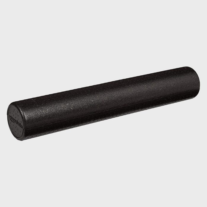 Foam roller, positioned diagonally, rests on a plain, light gray background.