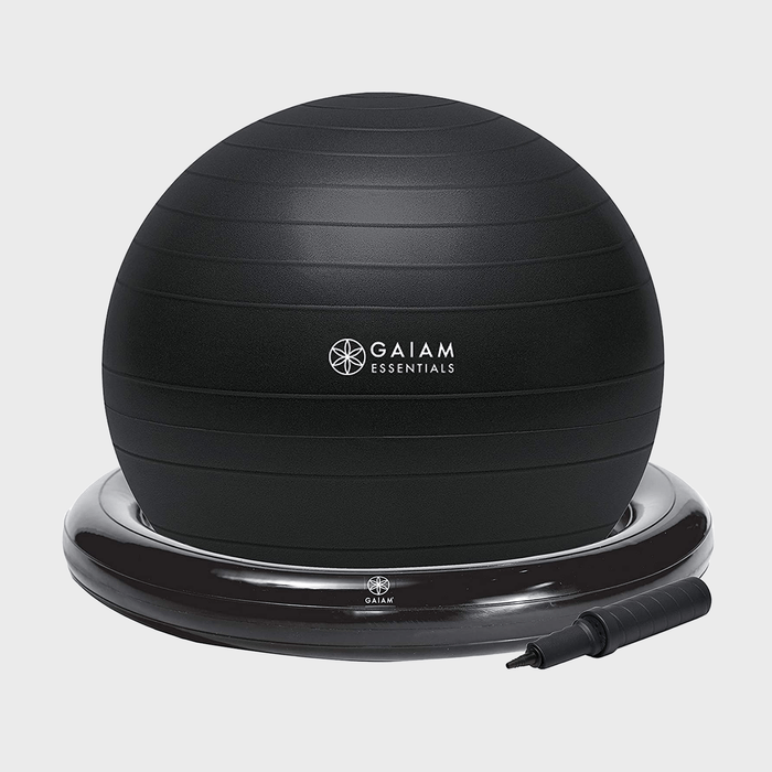 A black exercise ball sits on a circular base, with a hand pump nearby. Text reads 