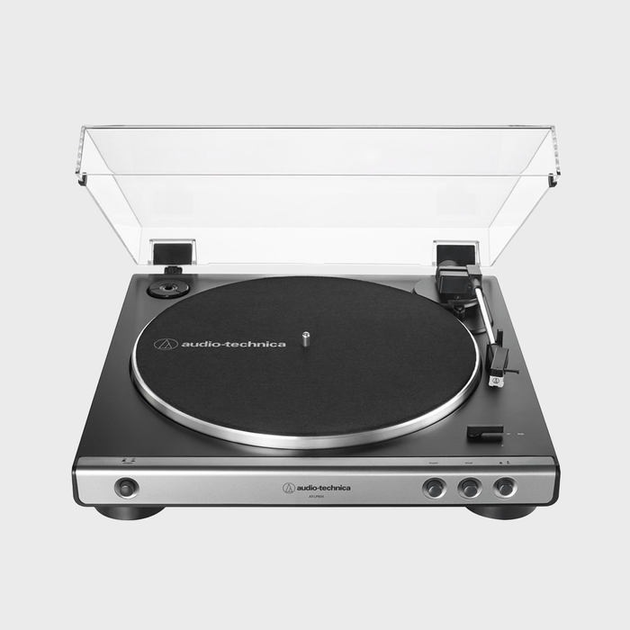Turntable with lifted transparent dust cover; positioned on a white background. Text on surface: 