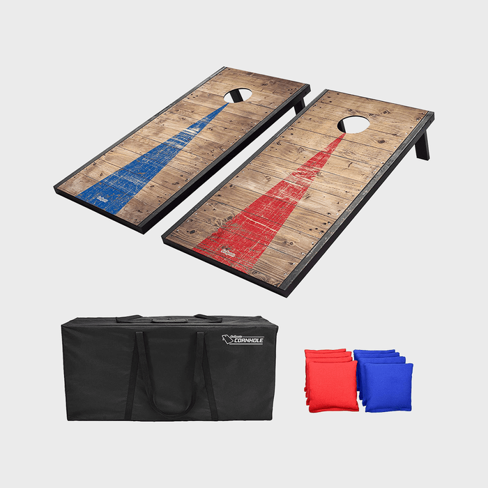 Two wooden cornhole boards with red and blue painted triangles, accompanied by a black carrying bag and red and blue bean bags.