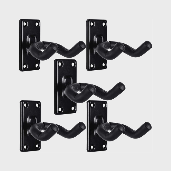Five black, padded wall-mounted guitar hangers on a plain white background, each with four screw holes for attachment.