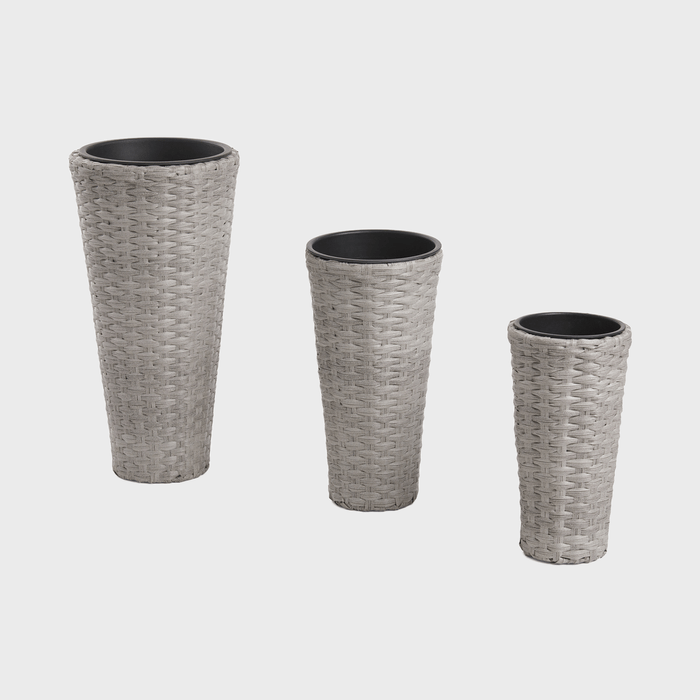 Three tall, tapered wicker planters stand side by side, differing in size, against a plain white background.