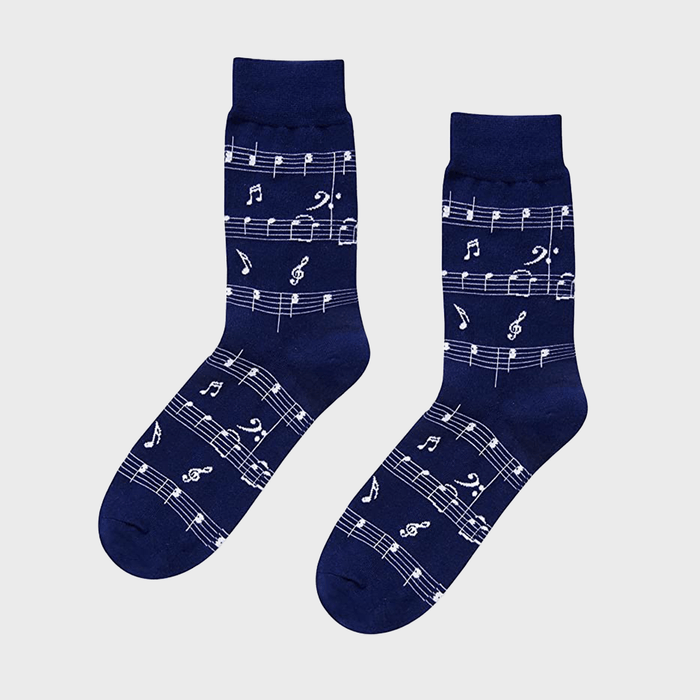 Navy blue socks featuring white musical notes and staffs, displayed against a plain gray background.
