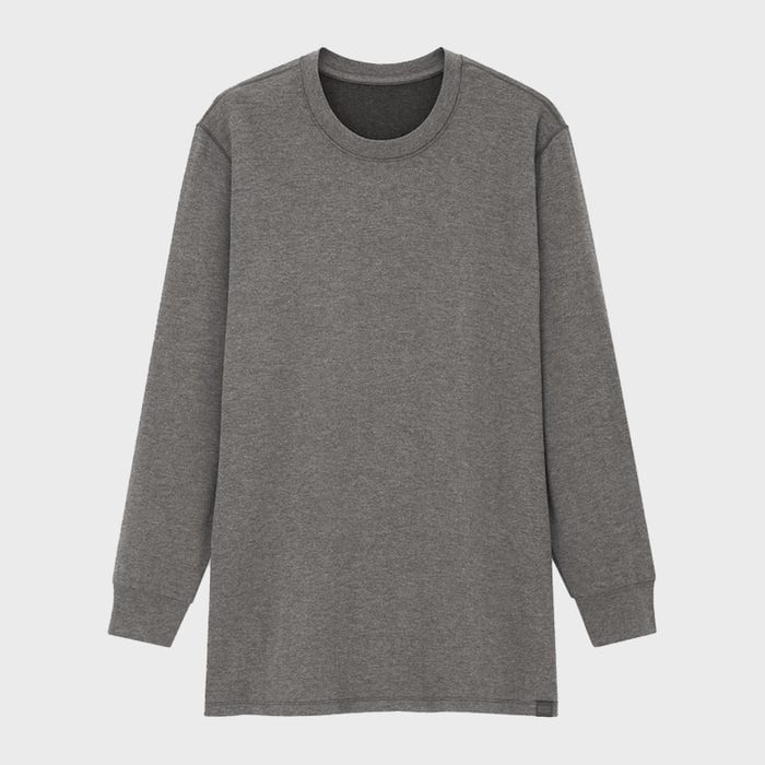 Grey long-sleeve t-shirt hangs against a plain white background, showcasing its simple, casual design.