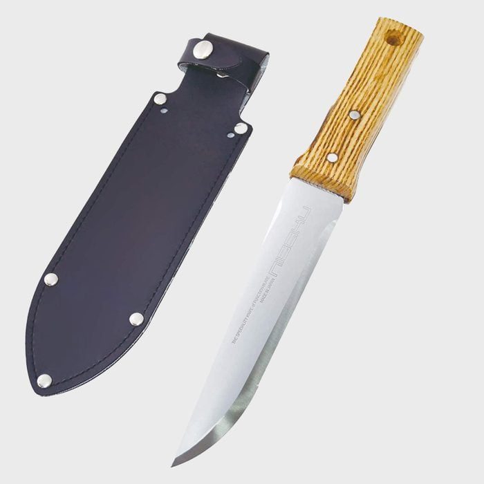 A large knife lies beside a black sheath. The knife has a polished silver blade and a wooden handle, placed on a plain gray surface.