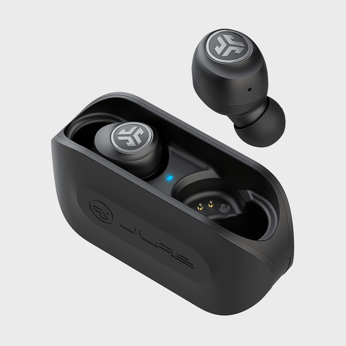 Earbuds resting in and above an open charging case; logo visible on buds and case, set against a gray background.