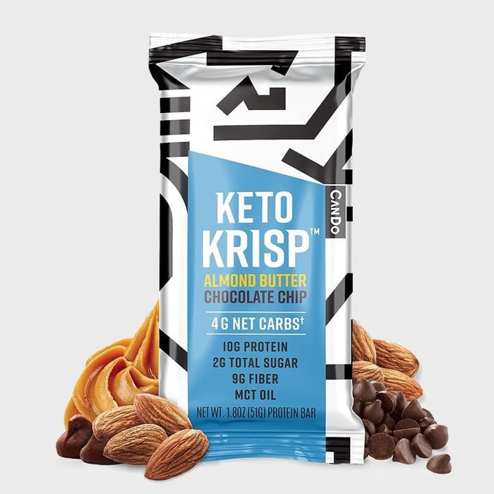 Protein bar displays ingredients with almonds and chocolate chips surrounding it; text highlights nutritional information: 10G protein, 4G net carbs, 2G sugar.