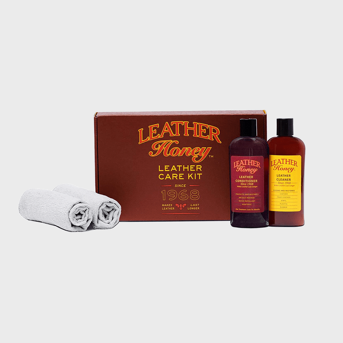 Kit includes leather conditioner, cleaner, and two cloths beside a box labeled â€œLeather Honey Leather Care Kit Since 1968