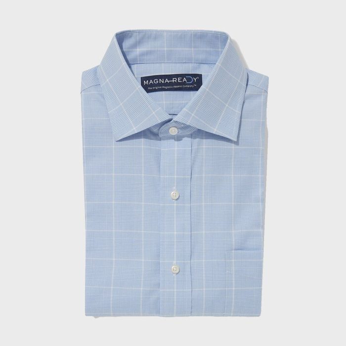 A neatly folded light blue checkered dress shirt with visible buttons lies against a plain, light gray background.