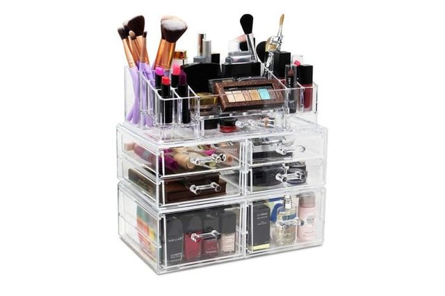 Acrylic makeup organizer holds brushes, lipsticks, and cosmetics, featuring multiple clear drawers and compartments in a neat, compact setup.