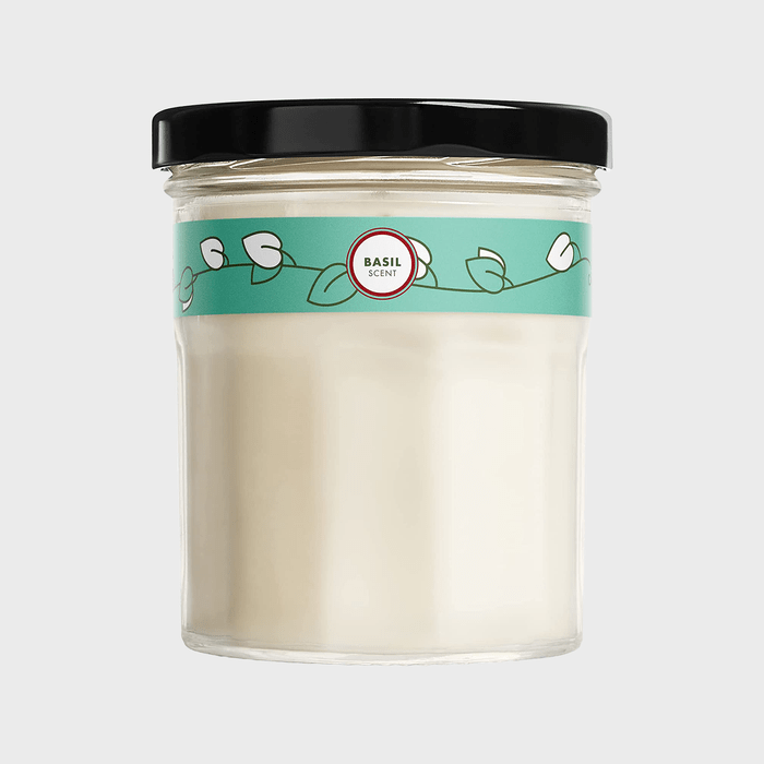 Glass jar with white wax, labeled 