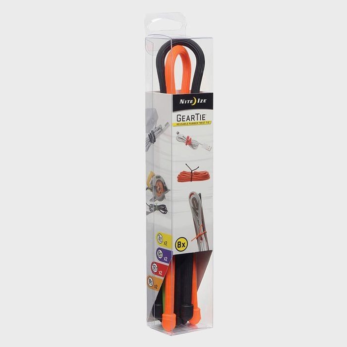 Package contains black and orange reusable twist ties neatly displayed. Packaging shows example uses for organizing cords, and states 