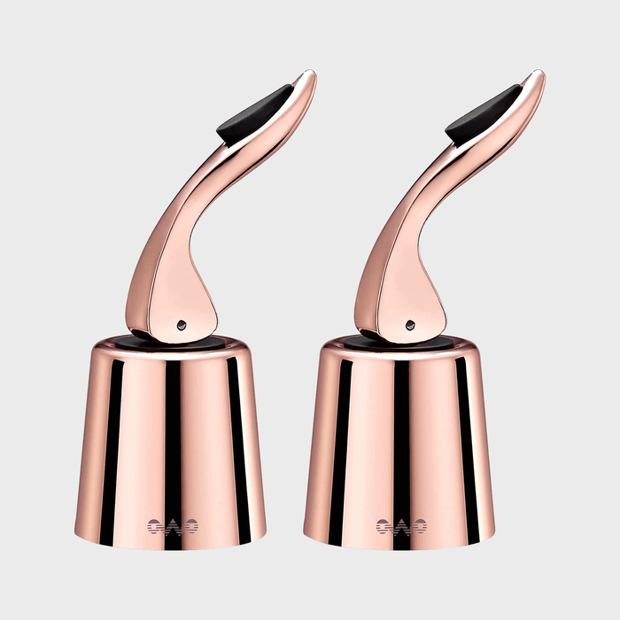 Two sleek, rose gold wine stoppers displayed vertically against a plain gray background.