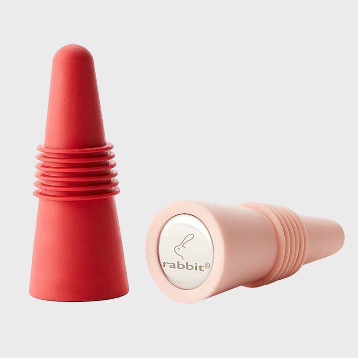 Two silicone bottle stoppers, one standing and one lying, display grooves; 