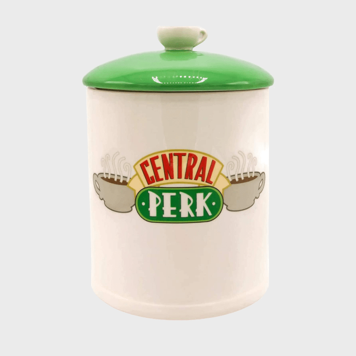 A ceramic jar with a green lid, displaying 