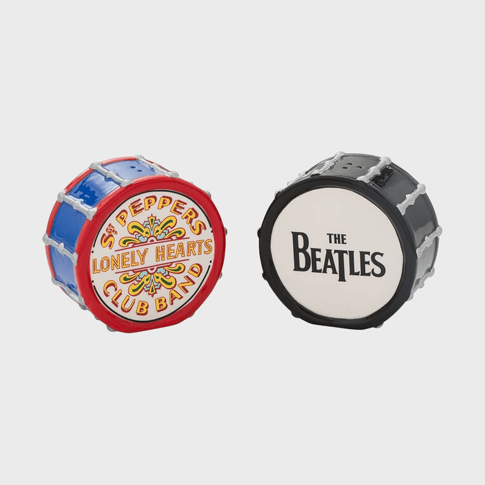 Two miniature drum-shaped objects display text: one reads 